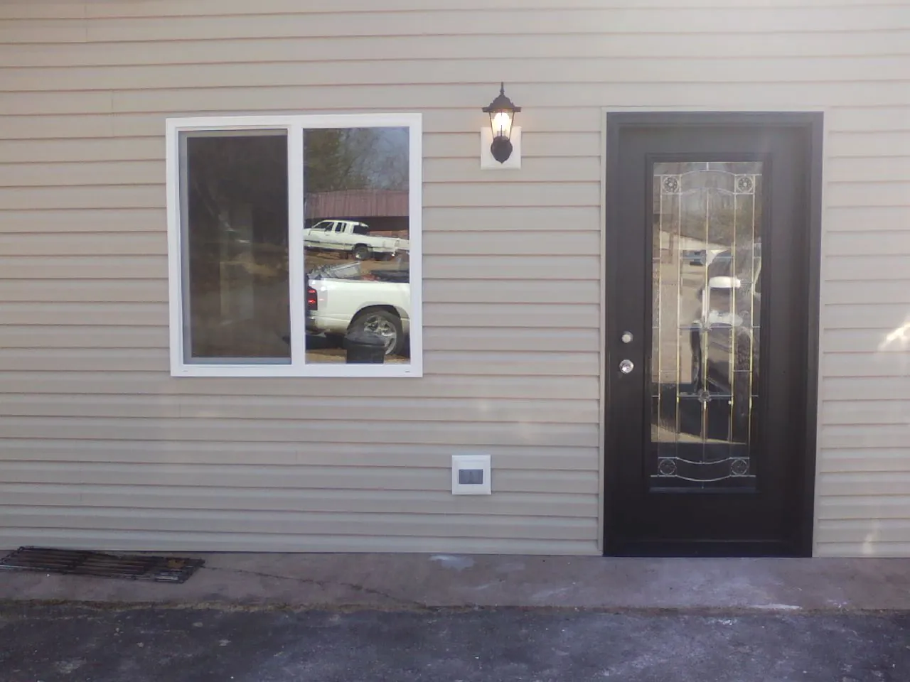 New siding, window and entry door on the side of an addition in Codorus