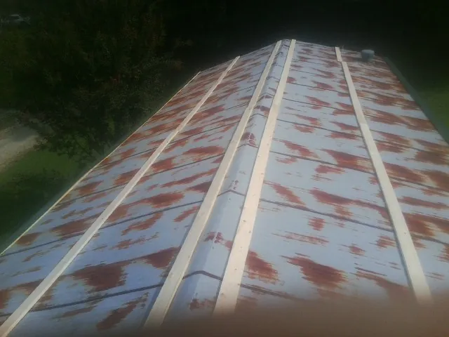 Rusted metal roof panels with new wood purlins before replacement — Storm Damage Roof Repair in Codorus by Roofing Brothers