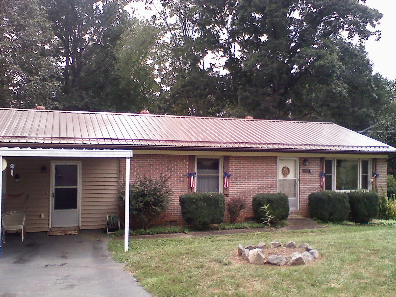 Bronze metal roof and carport on a brick ranch home — Roof Repair work by our crew in Codorus